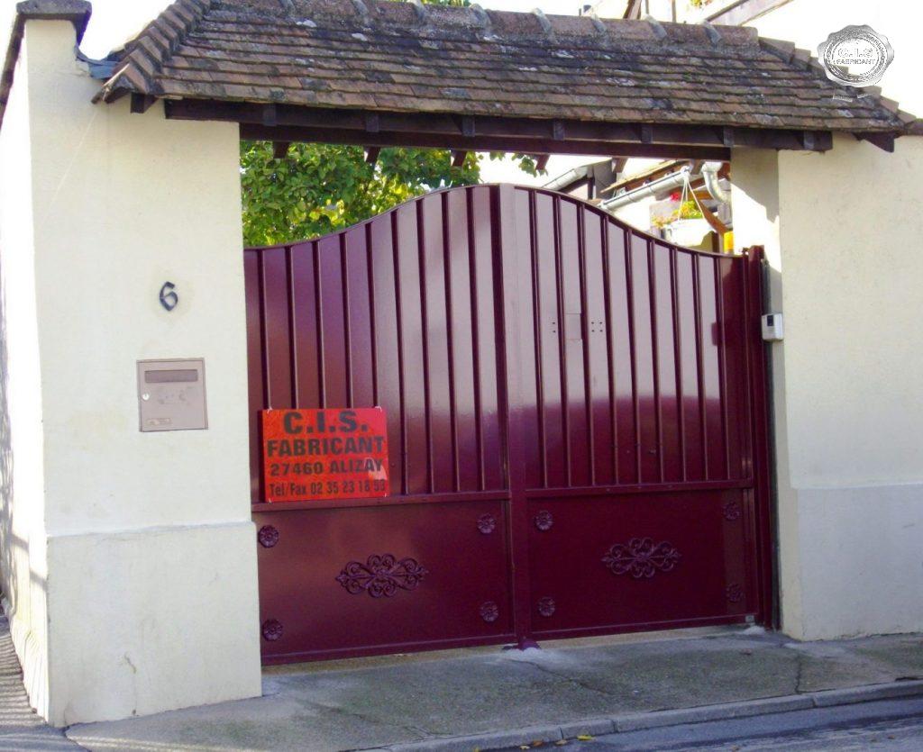 Portail classique plein rouge rubis situé à Louviers
